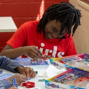 Girl smiling and building snap Circuits 
