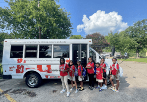 Girls in front of bus